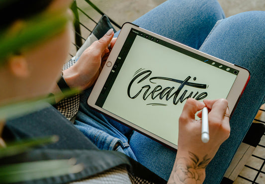 an artist using ipad and stylus