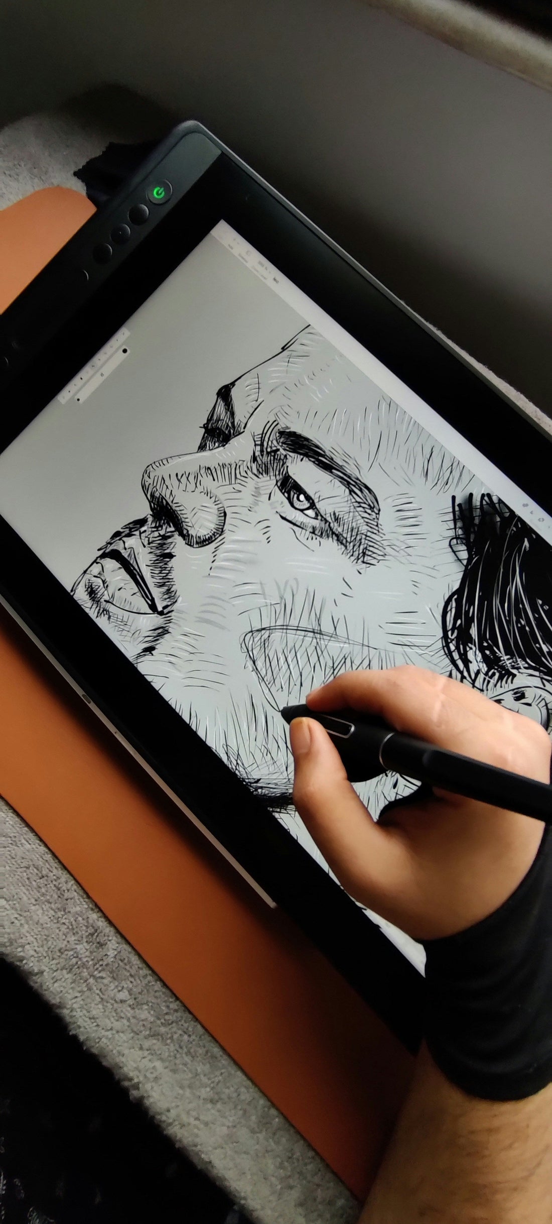 Hand in artist glove sketching on tablet with stylus