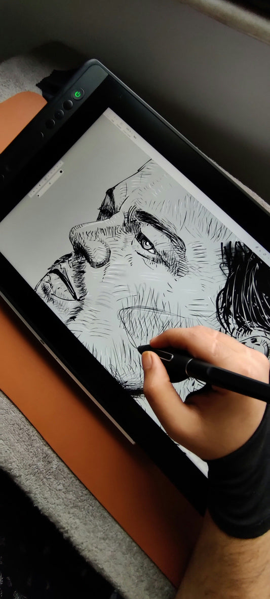 Hand in artist glove sketching on tablet with stylus